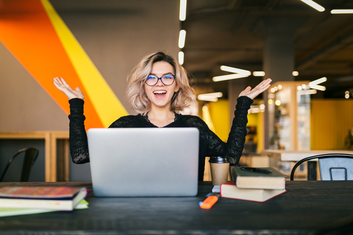 Happy remote worker with her hands in the air