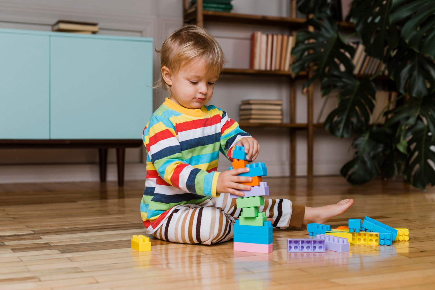 Small child playing with building blocks