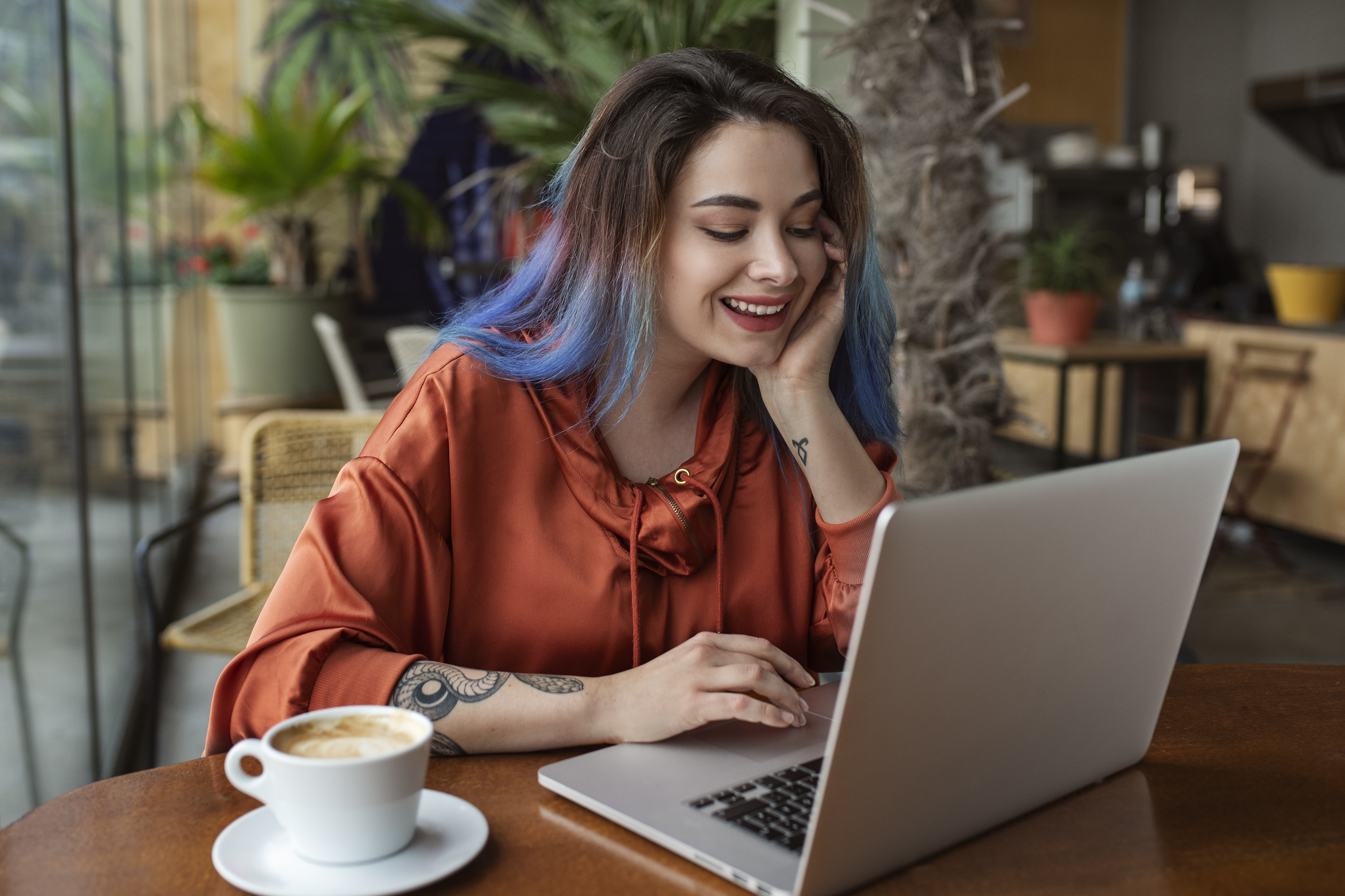 medium-shot-young-woman-sitting-coffee-shop