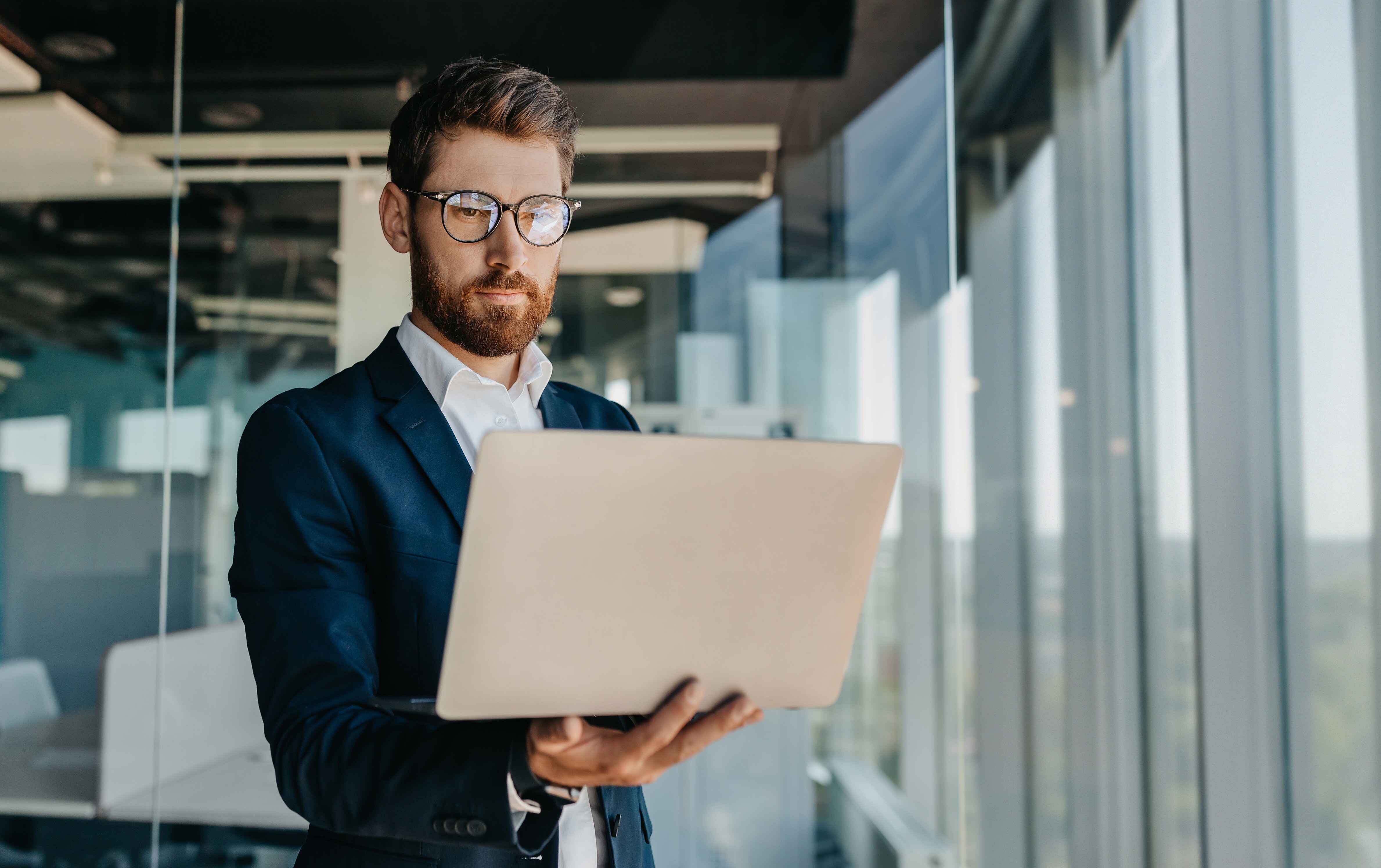 successful-middle-aged-businessman-with-laptop-hands
